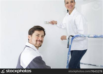 happy professional painters working indoors