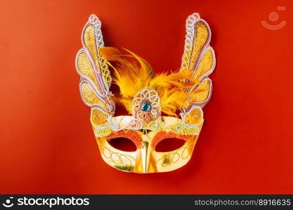 Happy Purim carnival. Carnival mask for Mardi Gras celebration isolated on red background with copy space, jewish holiday, Purim in Hebrew holiday carnival ball, Venetian mask, masquerade accessory