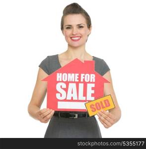 Happy realtor showing home for sale sold sign