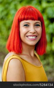 Happy red hair woman with yellow dress in a park