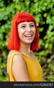 Happy red hair woman with yellow dress in a park