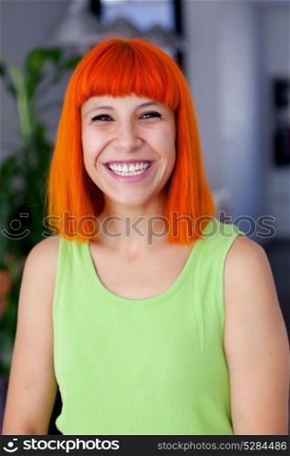 Happy redhead woman with green t-shirt at home