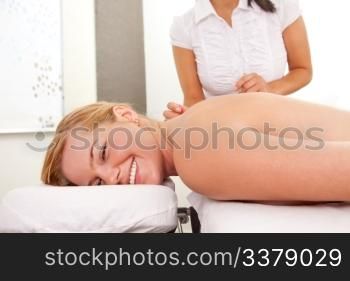 Happy relaxed woman acupuncture patient receiving a therapy treatment on the back