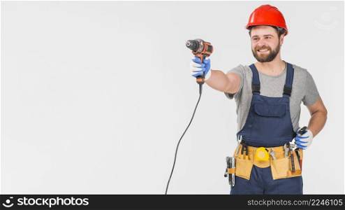happy repairman overall holding drill hand