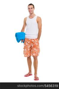 Happy resting on vacation young guy holding blue towel