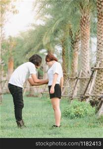 Happy romantic asian couple in love, Boyfriend take care of lover, Moments of happiness in the park.