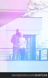 Happy romantic couple enjoying morning coffee together on balcony.travel, relationships, and happiness concept. couple enjoying morning coffee on balcony