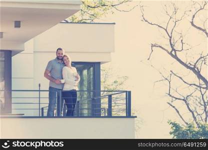 Happy romantic couple enjoying morning coffee together on balcony.travel, relationships, and happiness concept. couple enjoying morning coffee on balcony