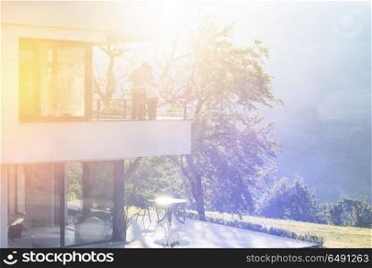 Happy romantic couple enjoying morning coffee together on balcony.travel, relationships, and happiness concept. couple enjoying morning coffee on balcony