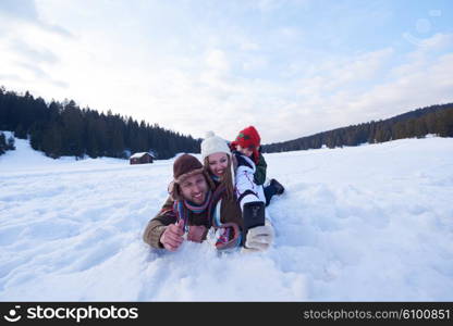 happy romantic couple have fun in fresh snow and taking selfie. Romantic winter scene in forest with young people