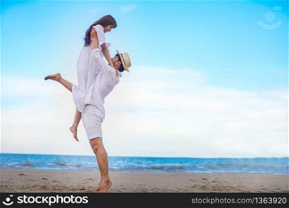 Happy Romantic Couples lover holding hands together walking on the beach