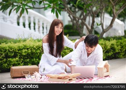 Happy Romantic Couples lover talking and drinking wine while having a picnic at home