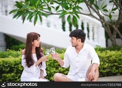 Happy Romantic Couples lover talking and drinking wine while having a picnic at home