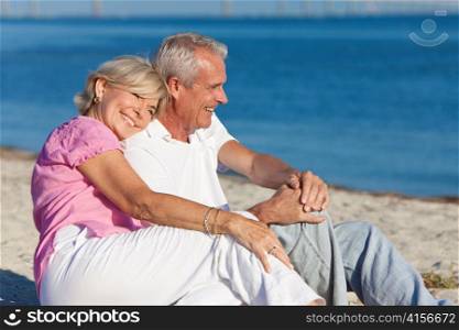 Happy Romantic Senior Couple Sitting Together on Beach