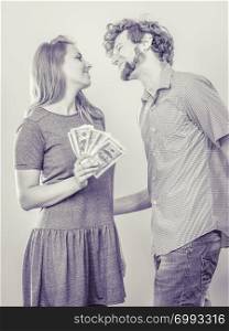 Happy romantic young couple. Smiling friends man and woman with dollar money in studio.. Happy couple man and woman with dollar money.