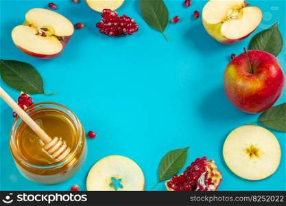 Happy Rosh Hashanah. Ho≠y, app≤s and pomegranates on a blue background. Round frame for your text. Jewish traditional religious holiday.. Happy Rosh Hashanah. Ho≠y, app≤s and pomegranates on blue background. Round frame for your text. Jewish traditional religious holiday.
