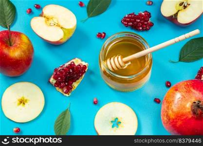 Happy Rosh Hashanah. Pattern from apples, honey and pomegranates on a blue background. Jewish traditional religious holiday.. Happy Rosh Hashanah. Pattern from apples, honey and pomegranates on blue background. Jewish traditional religious holiday.