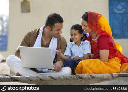 Happy rural family using laptop