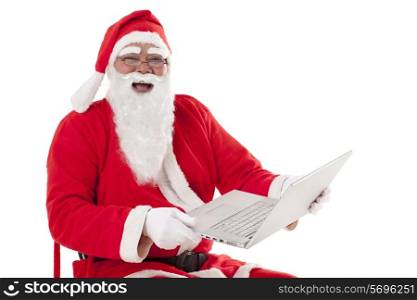 Happy Santa Claus using laptop over white background