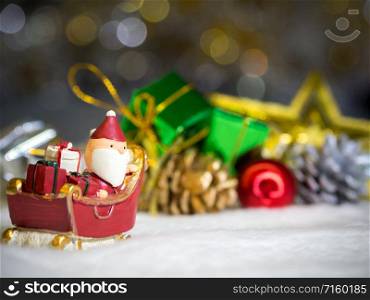 Happy Santa Claus with gifts box on the snow sled the background is Christmas decor.Santa Claus and Christmas decor on the snow. Merry Christmas and happy new year concept