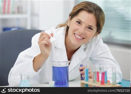 happy scientist with glass flask