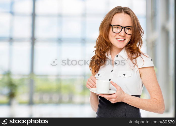 Happy secretary with coffee in the office