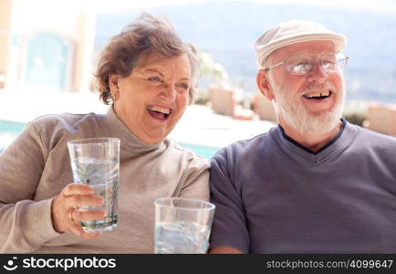 Happy Senior Adult Couple Enjoying Drinks Together.