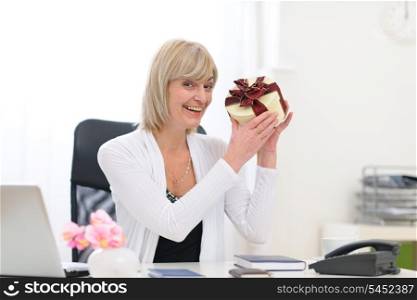 Happy senior business woman got present at office