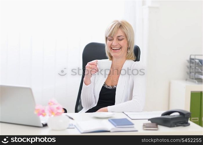 Happy senior business woman having coffee break