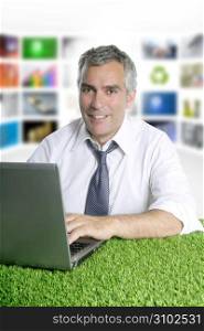 happy senior businessman working green grass desk tv presenter screen