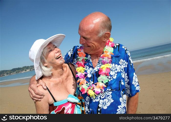 Happy senior couple at tropical beach