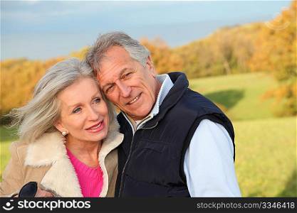 Happy senior couple embracing each other in countryside