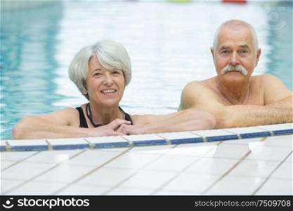 happy senior couple in the pool