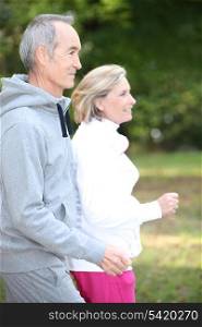 Happy senior couple jogging