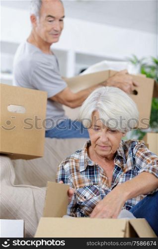 happy senior couple moving into their new home