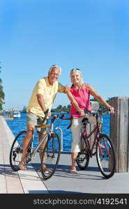 Happy Senior Couple on Bicycles By a River