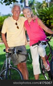 Happy Senior Couple on Bicycles In A Park