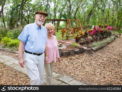 Happy senior couple taking an afternoon stroll in the park.