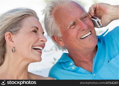 Happy Senior Couple Talking on Mobile Cell Phone