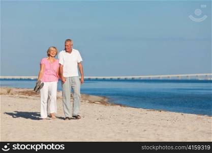 Happy Senior Couple Walking Holding Hands on Beach