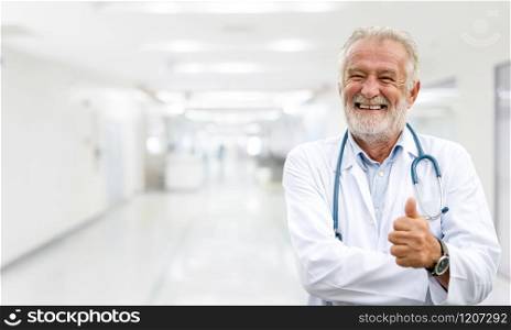 Happy senior doctor standing in the hospital. Medical healthcare business and doctor service.