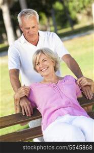 Happy senior man and woman couple smiling and laughing having fun together outside in sunshine
