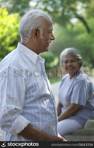 Happy senior man and woman smiling in park