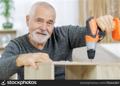 happy senior man dealing with diy work