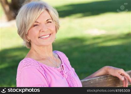 Happy Senior Woman Sitting Outside Smiling