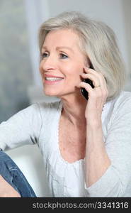 Happy senior woman talking on mobile phone