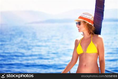 Happy sexy girl enjoying sea cruise, relaxation outdoors on the yacht, luxury summertime vacation, pleasure and enjoyment concept