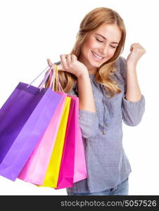 Happy shopper girl closed her eyes with pleasure and holding in hand colorful shopping bags, isolated on white background