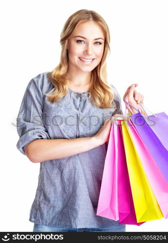 Happy shopper girl with four colourful paper bags isolated on white background, doing purchase, sale and spending money conception