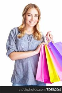 Happy shopper girl with four colourful paper bags isolated on white background, doing purchase, sale and spending money conception